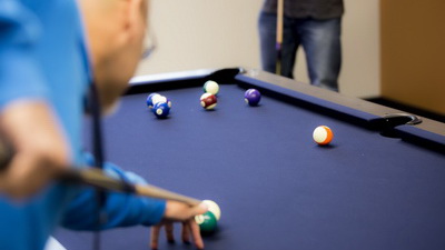 Fun-room that features a pool table, ping pong, shuffleboard, bubble hockey, TV, video games and even a jukebox.